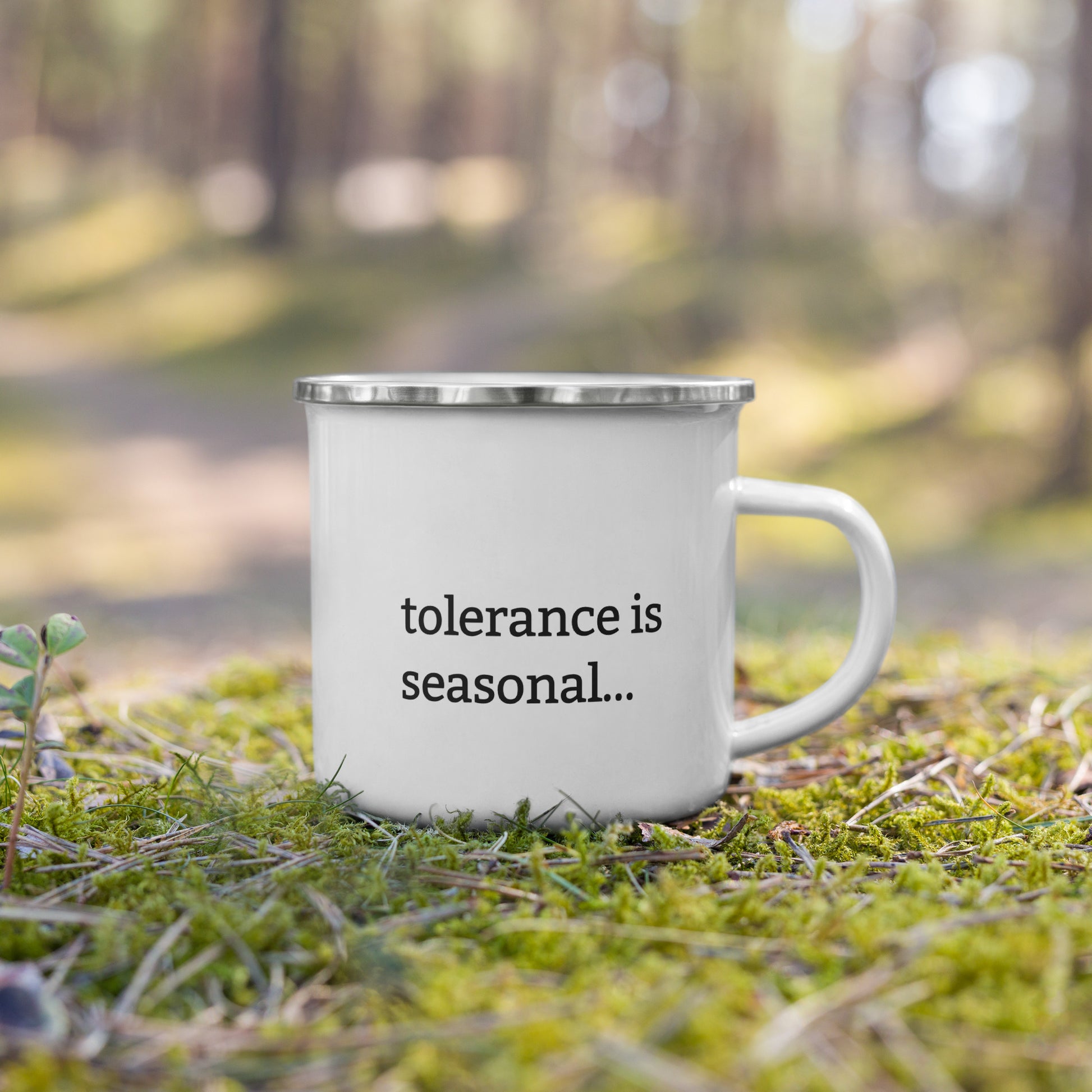 White enamel mug with black rim featuring “Like the soil I don’t like to be disturbed” and “Tolerance is seasonal” text