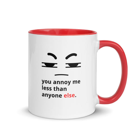 Snarky relationship mug with “You Annoy Me Less Than Anyone Else” text and frowning face design red handle and inside 