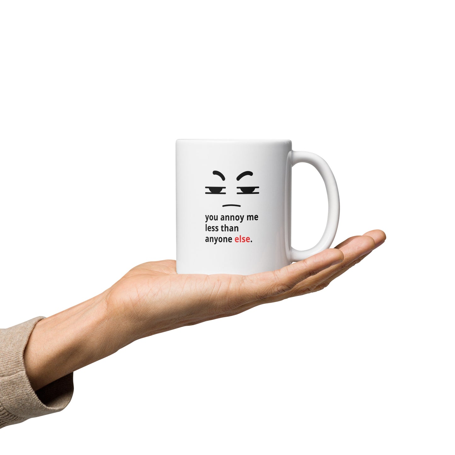 Snarky relationship mug with “You Annoy Me Less Than Anyone Else” text and frowning face design on hand 